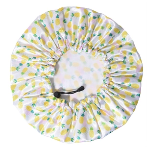 Close-up of waterproof satin shower cap with adjustable drawstring and yellow pineapple prints