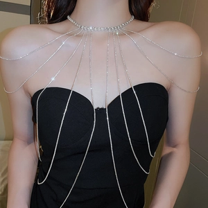 Close-up of sparkling silver rhinestone shoulder body chain on model for bridal gowns