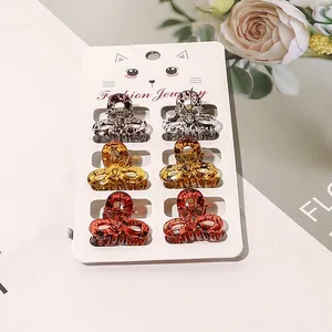 Set of 6 mini leopard print bow hair claws in various colors on display card