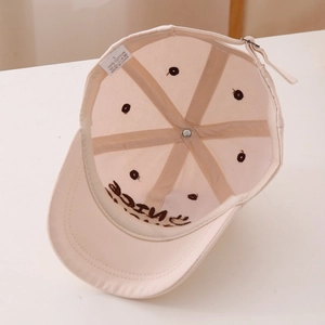 Detail view of cotton baseball cap interior showing 100% cotton label and stitching