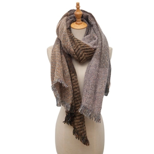 Detail shot of brown plaid scarf featuring soft blended fabric and decorative tassels