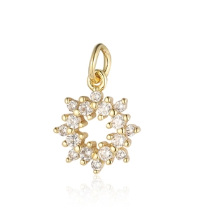 Detailed view of a gold-plated snowflake pendant with shimmering zircon stones and hanging loop