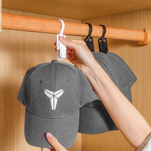 Multifunctional plastic swivel hook clips for hats and socks in a closet setting