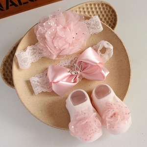 Pink lace baby headbands and knit socks set with sequin mesh flowers in a tray