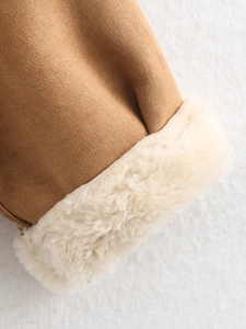 Detail of warm camel suede cuff with thick cream faux fur lining for winter jacket
