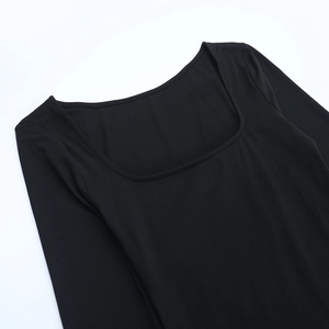 Close-up of the square neckline and stitching detail of the black long sleeve dress