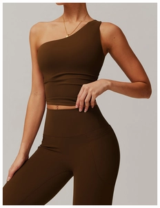 Detail view of coffee brown one-shoulder yoga top and high-waisted leggings with pocket