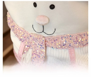 Close-up of pink plush Santa Claus chair cover face with sequins and embroidery