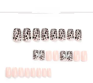 Macro shot of 24pcs pink press-on nails with leopard patterns and silver heart motifs