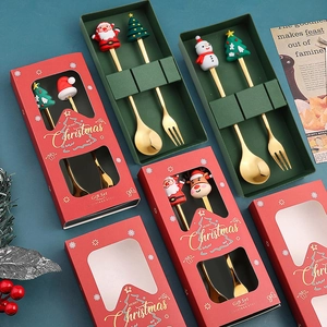 Detail of Christmas stainless steel spoon and fork set with festive cartoon toppers