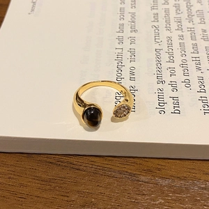 Macro shot of vintage 18k gold plated tiger eye stone ring with shimmering zircon details