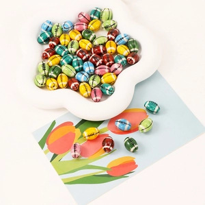 Macro view of multi-colored ceramic football beads for DIY bracelets and necklaces