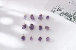 Detailed view of twelve natural amethyst raw stone pendants with gold plated caps and loops