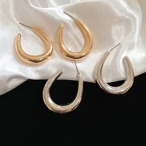 Minimalist U-shaped metal hoop earrings in gold and silver finish for women