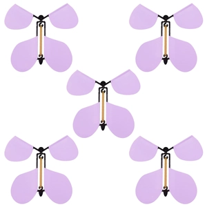 Flying butterfly magic toy with purple macaron wings and rubber band motor on white background