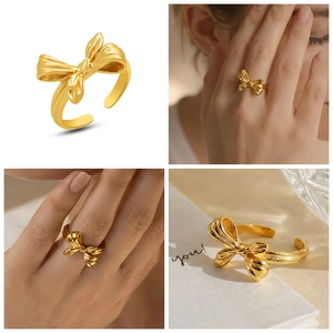 Macro detail of gold-plated stainless steel bow ring with adjustable open band design