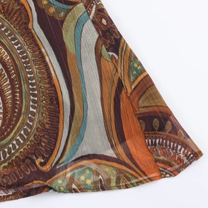 Detailed view of paisley print chiffon fabric with vertical micro-pleat texture