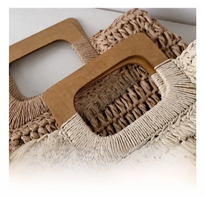 Detail of woven straw tote bags with rectangular wooden handles for beach vacation style