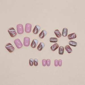 Sweet pink and white striped press-on nails with glitter accents in a short square shape