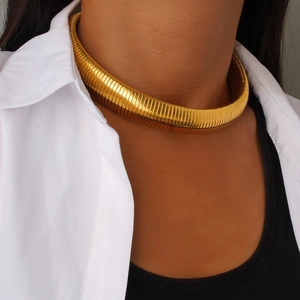 Elastic gold titanium steel choker necklace on model neck with minimalist outfit