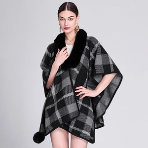 Women's black and grey plaid poncho with faux rabbit fur collar and pompom details