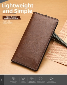 Detailed view of a brown long leather business wallet with lychee texture on a wooden table