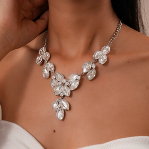 Close-up of elegant leaf-shaped crystal necklace with marquise-cut stones on a model