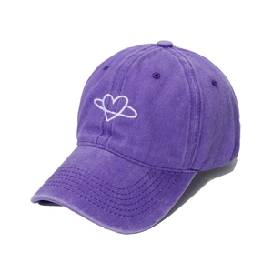 Vintage washed purple baseball cap with white embroidered heart planet logo in center