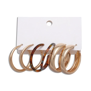 Three-pair hoop earring set with chunky gold metal and amber tortoiseshell textures