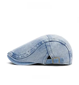 Side view of washed denim flat cap featuring adjustable metal buckle and stitching