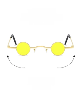 Detail of retro small round punk sunglasses with gold metal frame and yellow lenses