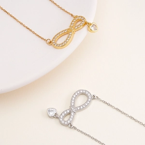 Minimalist infinity heart necklace in gold and silver with sparkling cubic zirconia