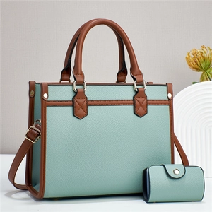 Close-up of light blue and brown contrast tote bag with a matching small wallet set