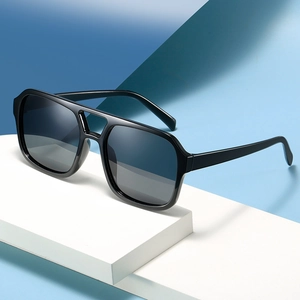 Classic square aviator sunglasses with black frames and gradient grey lenses on geometric blocks