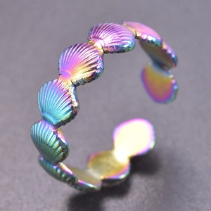 Macro shot of rainbow-plated stainless steel shell pattern open ring with metallic texture