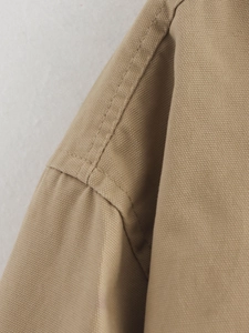 Detailed close-up of heavy canvas jacket seams with high-quality double-needle stitching