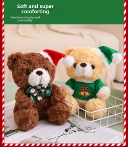Close-up of brown and beige Christmas teddy bears with red hats and festive sweaters
