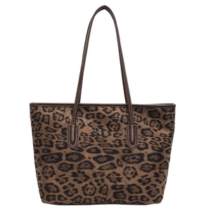 Large leopard print tote bag with brown leather shoulder straps on a white background