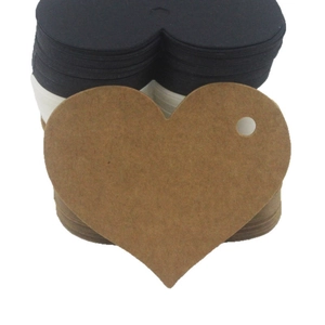 Set of heart-shaped kraft paper gift tags in black, white and brown for DIY crafts