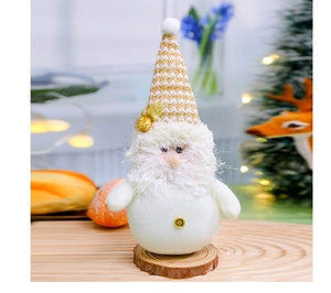 Close-up of a Christmas gnome doll with golden knit hat on a wooden base