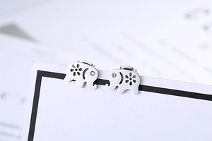 Macro detail of elephant stud earrings with floral cutouts and small sparkling crystals