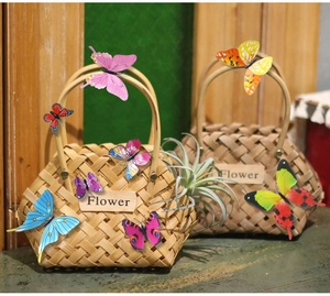 Macro detail of handmade bamboo basket with wooden handle and 3D decorative butterflies