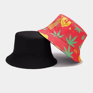 Detail view of double-sided bucket hats in black and red with printed floral motifs