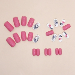 Matte pink press-on nails with silver glitter and floral art in square-oval shape