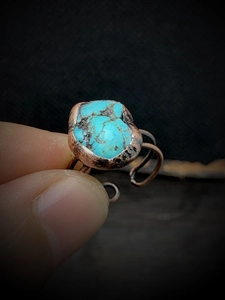 Close-up of handmade copper ring featuring a natural irregular green turquoise stone