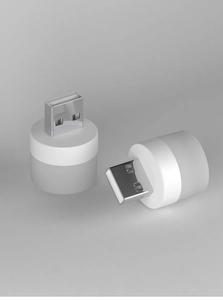 Detailed macro view of two portable white USB LED night lights with silver connectors