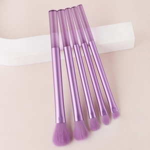 Detailed view of 5 mini purple makeup brushes with glitter crystal handles and soft bristles