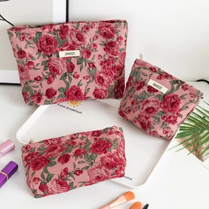Three-piece floral toiletry bag set in vintage red rose pattern with zipper closure