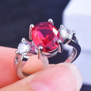 Macro shot of S925 sterling silver ring with oval ruby main stone and side cubic zirconia