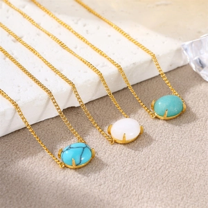 Detailed macro shot of 18k gold chain necklaces with colorful oval natural stones